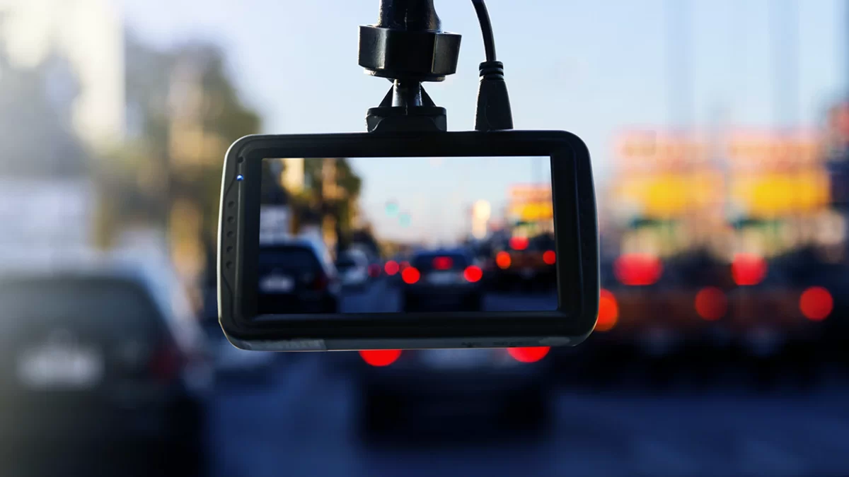 Dash cam mounted on a windshield recording traffic
